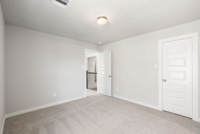 unfurnished room with light carpet