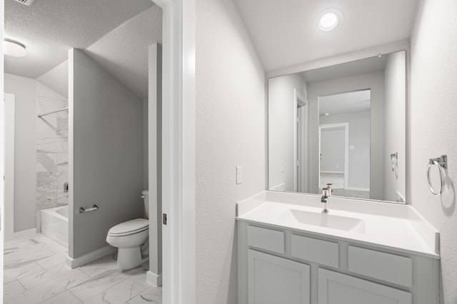 8427 Northern Pintail Dr, Houston, TX 77049 - bathroom featuring a textured ceiling, baseboards, marble finish floor, toilet, and vanity