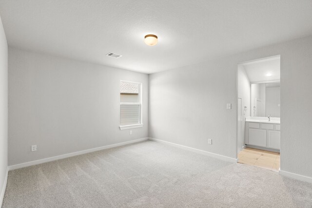 8427 Northern Pintail Dr, Houston, TX 77049 - unfurnished room with baseboards, visible vents, a sink, and light colored carpet
