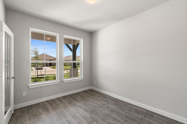 spare room with dark wood-type flooring