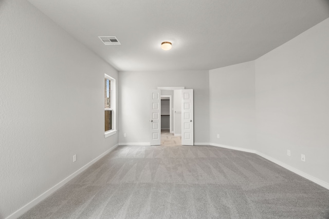 8427 Northern Pintail Dr, Houston, TX 77049 - empty room featuring light carpet, baseboards, and visible vents