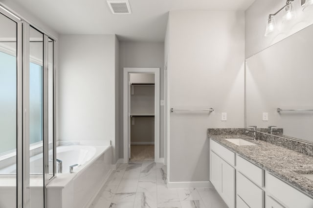 bathroom with vanity and a washtub