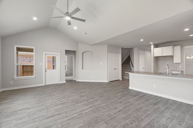 8427 Northern Pintail Dr, Houston, TX 77049 - unfurnished living room featuring a ceiling fan, light wood-style floors, a sink, and stairway