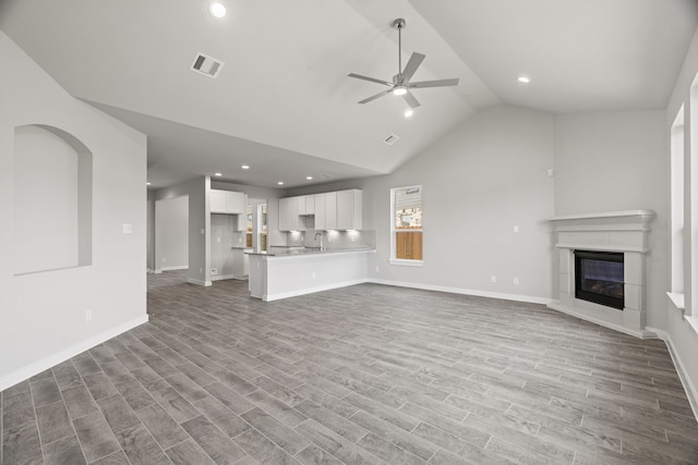 8427 Northern Pintail Dr, Houston, TX 77049 - unfurnished living room with visible vents, wood finished floors, ceiling fan, and a sink