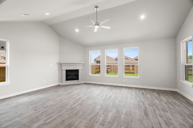 unfurnished living room with a fireplace, lofted ceiling, light hardwood / wood-style flooring, and ceiling fan