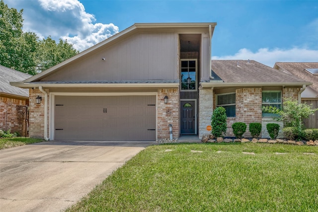 view of front of home featuring a garage and a front lawn