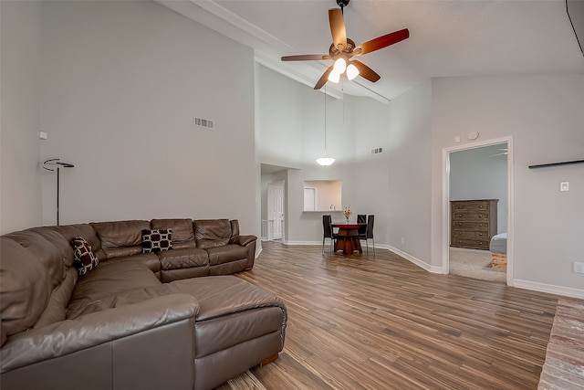 living room featuring high vaulted ceiling, ceiling fan, and wood-type flooring