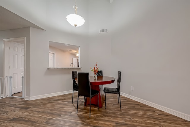 dining area featuring dark wood-type flooring