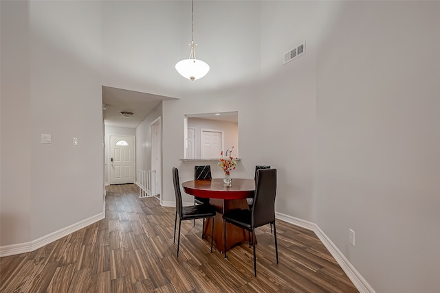 dining space with dark hardwood / wood-style flooring