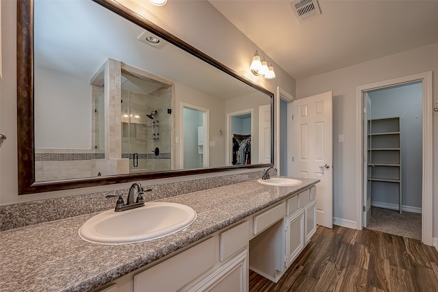 bathroom featuring vanity, hardwood / wood-style floors, and an enclosed shower