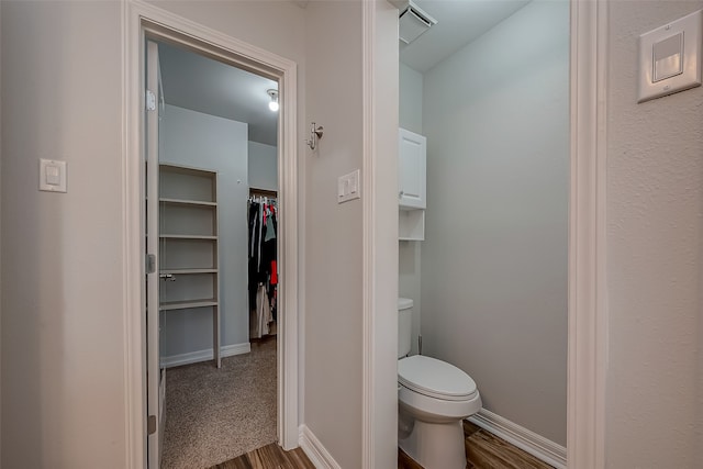 bathroom featuring wood-type flooring and toilet