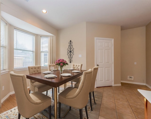 dining space with recessed lighting, baseboards, and light tile patterned flooring