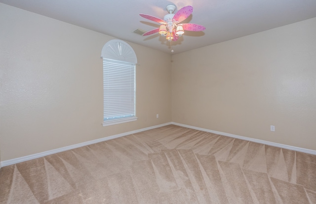 carpeted spare room with ceiling fan