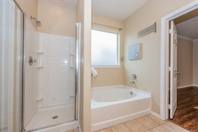 bathroom featuring wood-type flooring, shower with separate bathtub, and crown molding