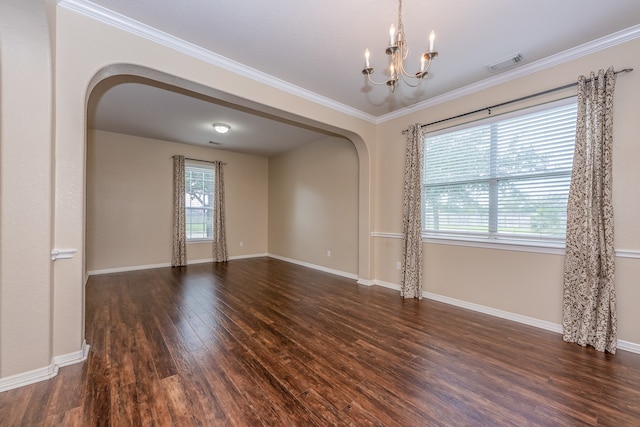 unfurnished room featuring crown molding, dark hardwood / wood-style flooring, and a chandelier