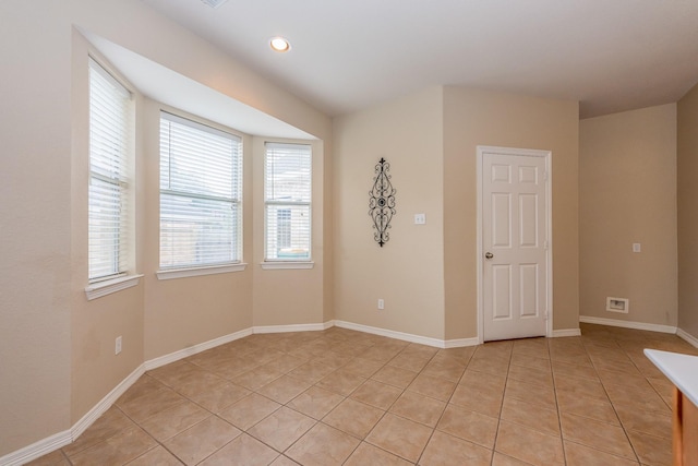 spare room with recessed lighting, baseboards, and light tile patterned floors