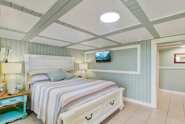 tiled bedroom featuring coffered ceiling and wood walls