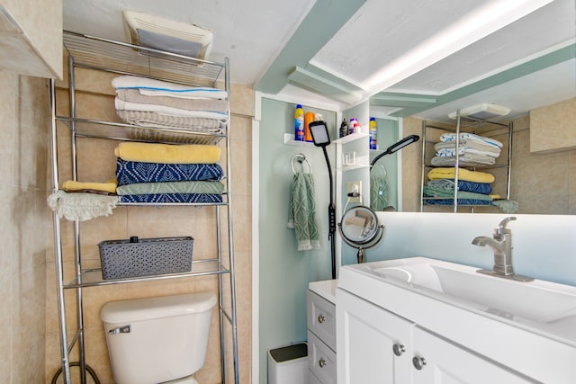 bathroom featuring toilet and vanity