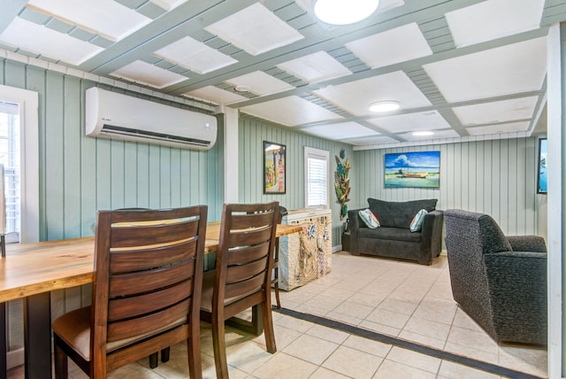 tiled dining area featuring a healthy amount of sunlight, wood walls, and a wall unit AC