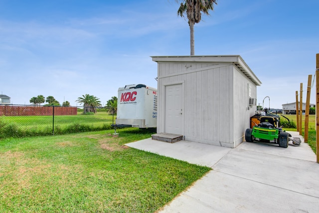 view of outbuilding featuring a yard