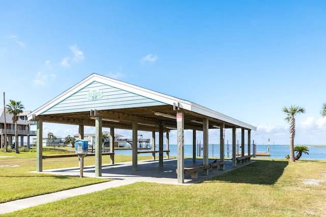 surrounding community with a gazebo, a yard, and a water view