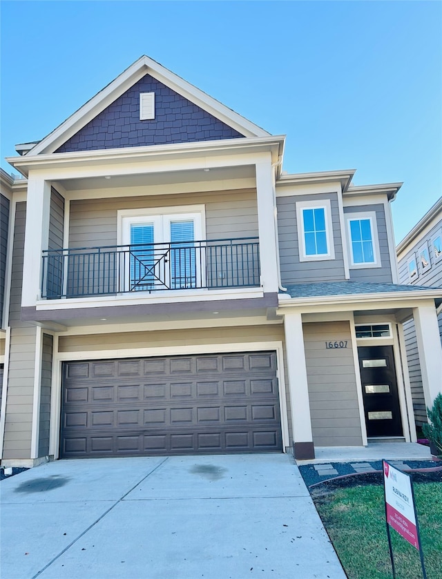 view of front of home with a balcony and a garage