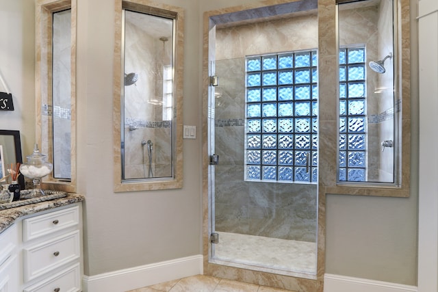 bathroom featuring tile patterned flooring, vanity, and a shower with shower door