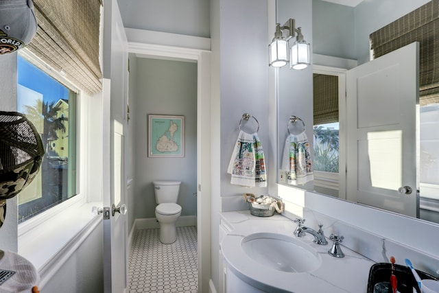 bathroom with tile patterned flooring, vanity, and toilet