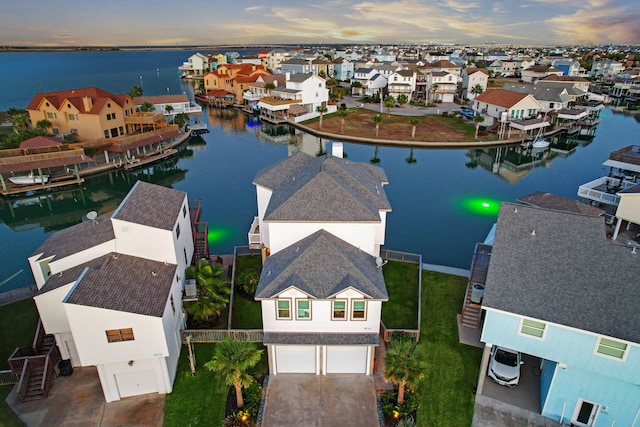 aerial view at dusk with a water view