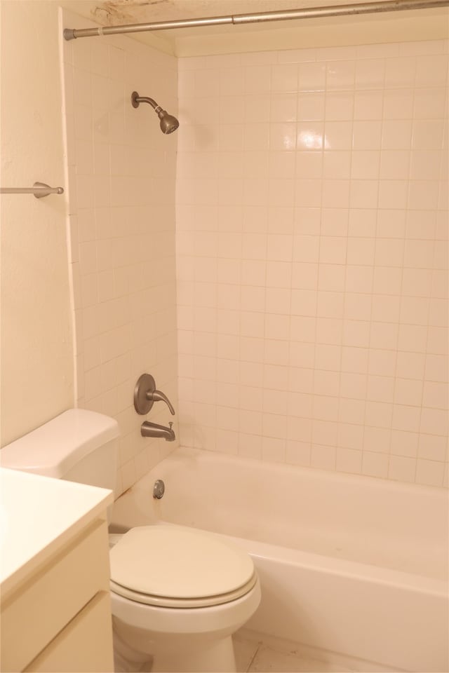 full bathroom with tiled shower / bath, toilet, and vanity