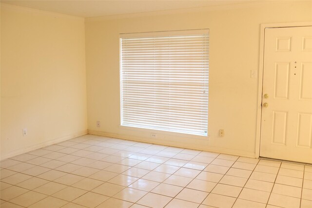 tiled spare room with crown molding