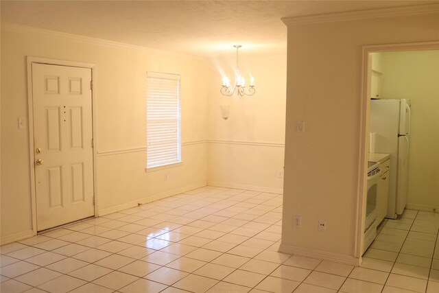 spare room with crown molding, an inviting chandelier, and light tile patterned floors