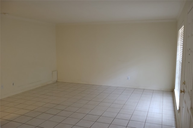 unfurnished room with light tile patterned floors and crown molding