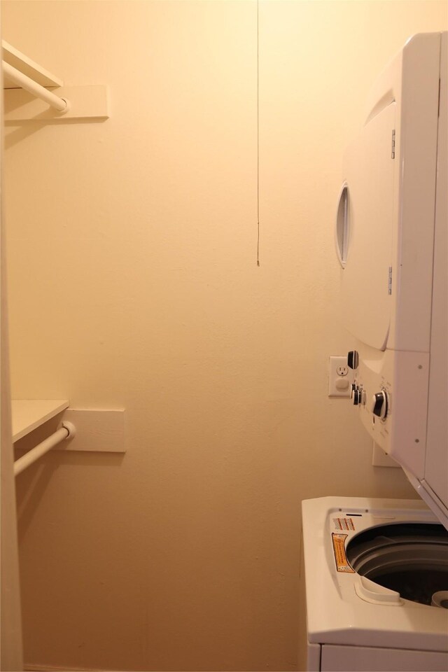 laundry area with stacked washer / drying machine