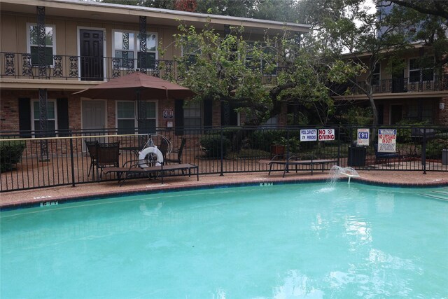 view of swimming pool featuring pool water feature