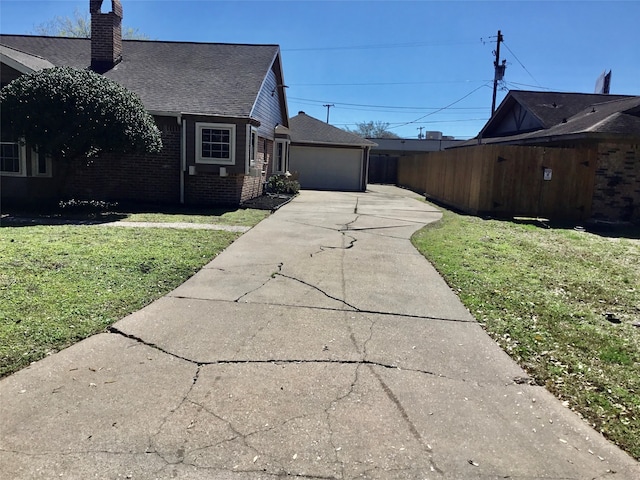 view of side of home with a yard and a garage