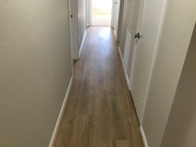 corridor with wood-type flooring