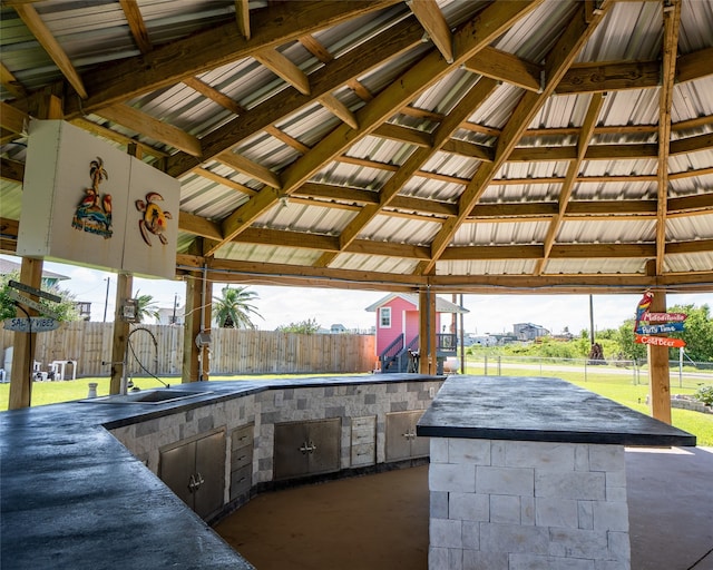 view of patio / terrace with an outdoor wet bar and area for grilling