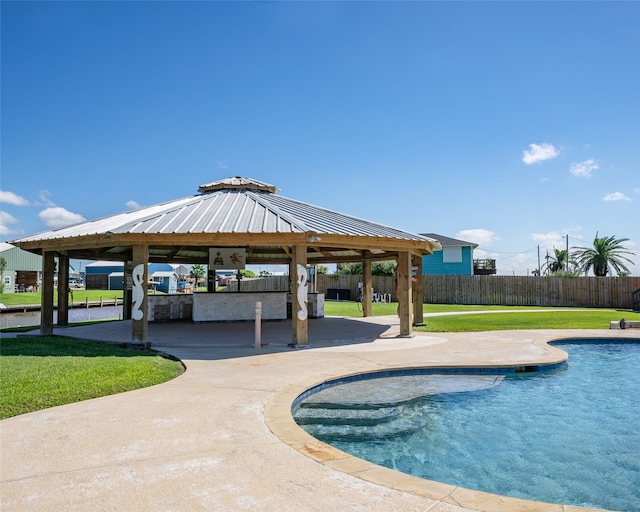 view of swimming pool featuring a lawn, a patio, and a gazebo