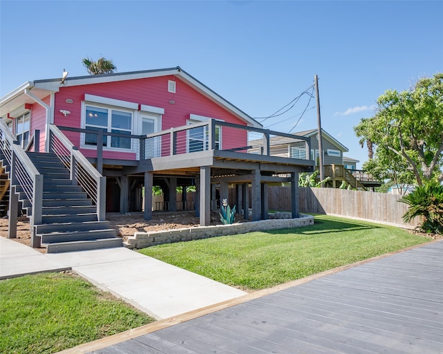 view of front of house featuring a wooden deck and a front lawn