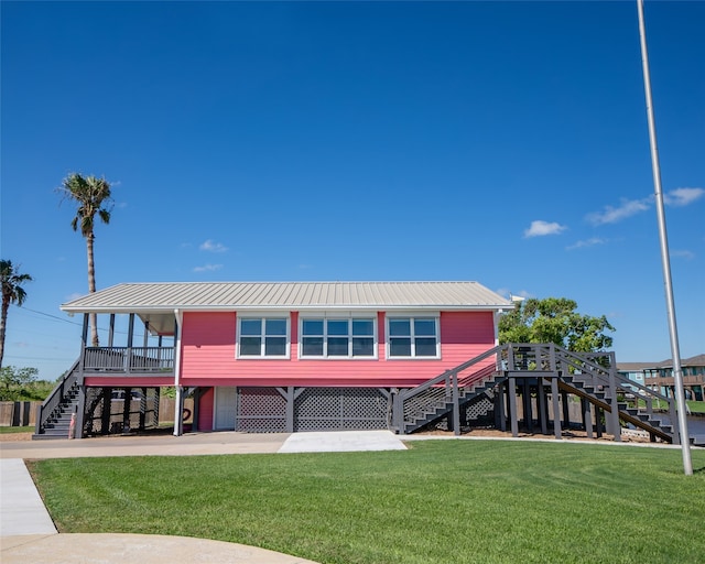 back of property with a yard and a carport