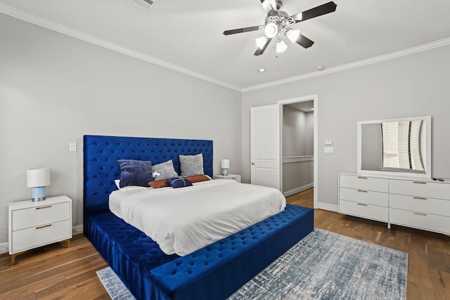 bedroom with dark wood-type flooring, ceiling fan, and crown molding