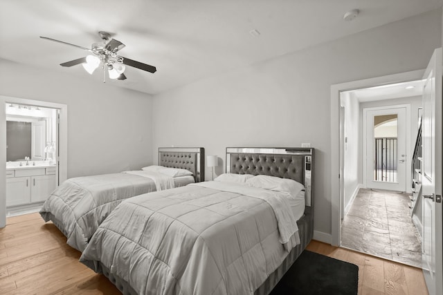 bedroom with connected bathroom, sink, ceiling fan, and light hardwood / wood-style floors