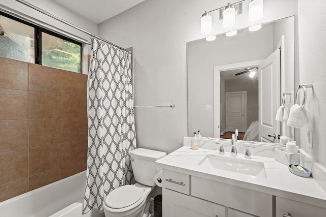 full bathroom with vanity, toilet, shower / bath combo with shower curtain, and ceiling fan