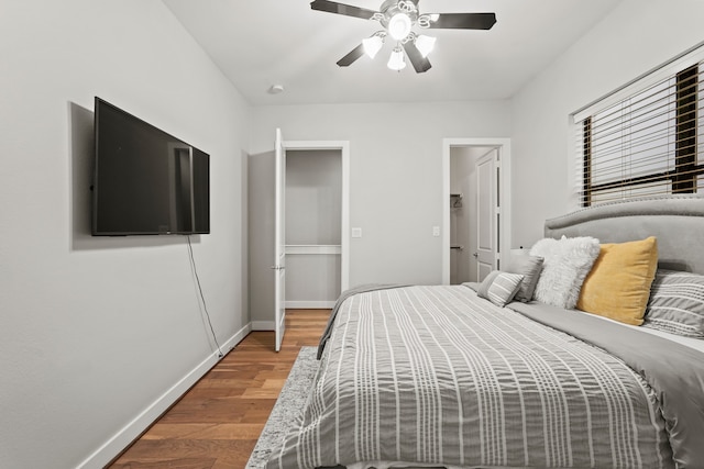 bedroom with ceiling fan and wood-type flooring