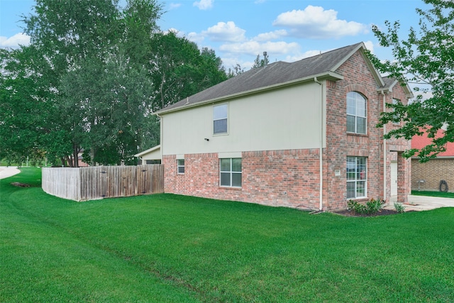 view of side of property featuring a yard