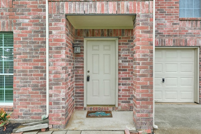 doorway to property with a garage