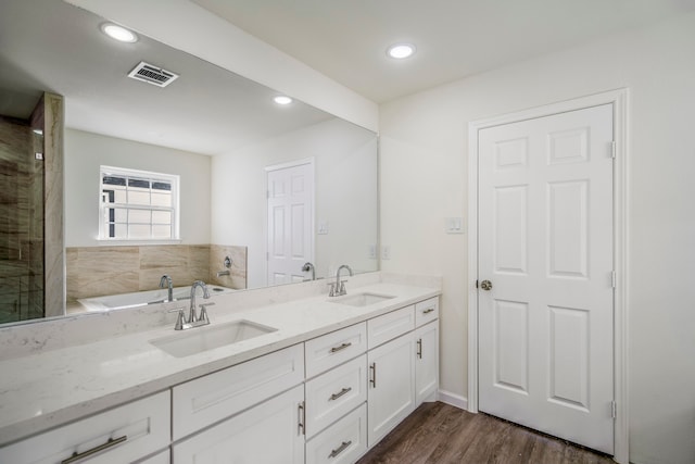 bathroom with vanity, separate shower and tub, and hardwood / wood-style floors