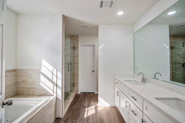 bathroom featuring vanity, hardwood / wood-style floors, and shower with separate bathtub