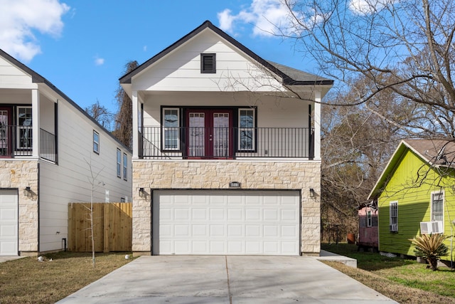 view of front of property with a garage, a balcony, and a front yard